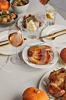 Thanksgiving dinner with baked vegetables, glasses