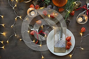 Thanksgiving dinner. Festive table with pumpkin, autumn leaves and seasonal autumn decor. Table setting in autumn style with a