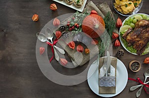 Thanksgiving dinner. Festive table with pumpkin, autumn leaves and seasonal autumn decor. Table setting in autumn style with a