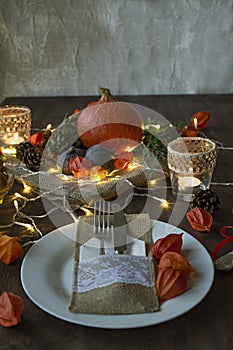 Thanksgiving dinner. Halloween dinner. Festive table with chicken and all side dishes, pumpkin, autumn leaves and seasonal autumn