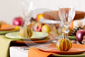 Thanksgiving dinner. Seasonal table setting with autumn leaves,