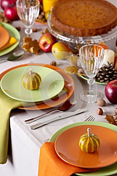 Thanksgiving dinner. Seasonal table setting with autumn leaves,