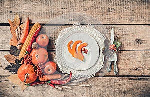 Autumn table setting, menu composition, vintage cutlery, sliced pumpkin.