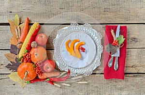 Autumn table setting, menu composition, vintage cutlery, sliced pumpkin.