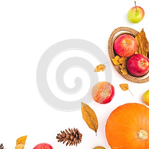 Thanksgiving frame made of fall dried leaves, pine cones, apples and pumpkin on white background. Flat lay, top view. Autumn compo