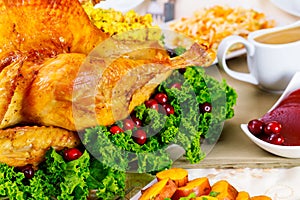 For Thanksgiving herbs and cranberries are used to decorate the turkey.