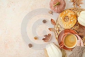 Thanksgiving holiday  background with coffee cup, cookie, white pumpkin and woman`s hand n warm sweater. Top view, flat lay