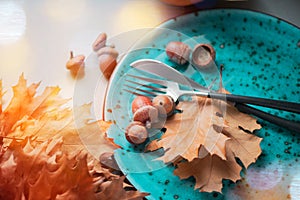 Thanksgiving. Holiday dinner table served, decorated with bright autumn leaves