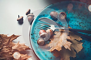 Thanksgiving holiday table served. Wooden table decorated with autumn leaves