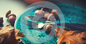 Thanksgiving holiday table served. Wooden table decorated with autumn leaves