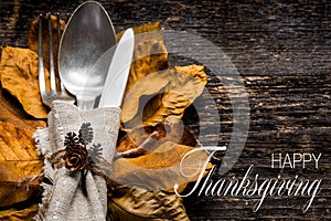 Thanksgiving Meal Setting. Seasonal table setting. Thanksgiving autumn place setting with cutlery and autumn leaves.