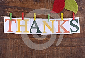 Thanksgiving party bunting on dark wood background.