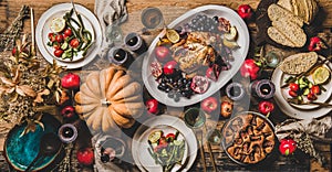 Thanksgiving party table setting with roasted chicken seasonal produce