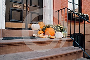 Thanksgiving pumpkin decorations on a stoop of a house in Manhattan, New York, USA