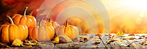 Thanksgiving Pumpkins And Leaves On Rustic Wooden Table