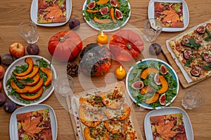 Thanksgiving table served, decorated with bright autumn leaves