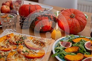 Thanksgiving table served, decorated with bright autumn leaves