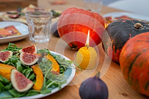 Thanksgiving table served, decorated with bright autumn leaves