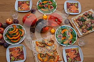 Thanksgiving table served, decorated with bright autumn leaves