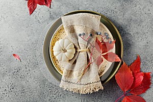 Thanksgiving table setting with autumn leaves