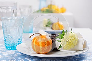 Thanksgiving table setting with decorative pumpkins
