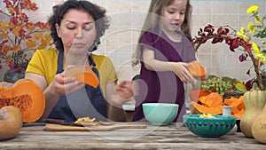 Thanksgiving Tradition, Pumpkin Pie. Happy mother and child cooks pumpkin pie for harvest festival. Festive dinner