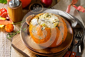 Thanksgiving Turkey dinner. Baked pumpkin stuffed with Turkey, rice and vegetables. The concept of food on