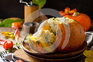 Thanksgiving Turkey dinner. Baked pumpkin stuffed with Turkey, rice and vegetables. The concept of food on