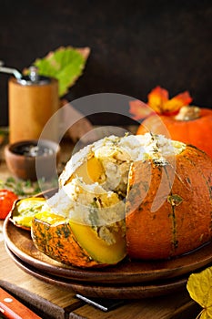 Thanksgiving Turkey dinner. Baked pumpkin stuffed with Turkey, rice and vegetables. The concept of food on