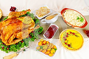 For Thanksgiving, a whole turkey decorated with herbs and cranberries is served.