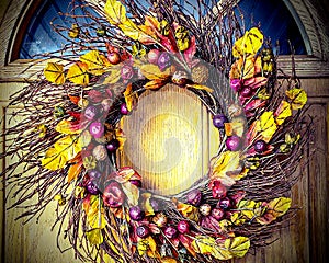 Thanksgiving wreath with fall colors, leaves, berries, and twigs