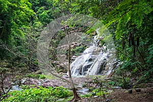 Thanthip Waterfall in the green forest with streamed water flowing on the step of rocks at Lom Sak District, Phetchabun province,