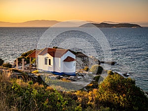 Thasos, Greece, beautiful view at sunset overlooking the sea with a small church visible in the front