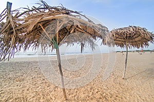 Thatch umbrellas on paradise beach in pondicherry chennai