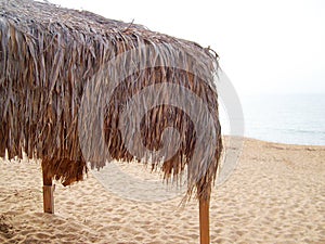 Thatched canopy on the empty sea beach