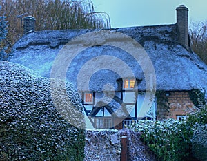 Thatched cottage with snow