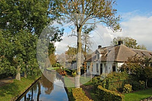Thatched house on waterside photo