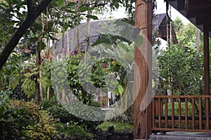 A thatched roof building that stands firmly in a garden.