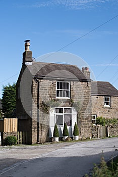 Thatched roof cottage in a typical English village with scenic views of Exmoor national park. Copy space for text.