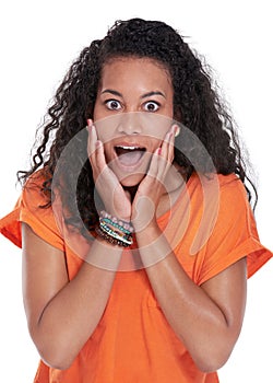 Thats amazing. Portrait of a beautiful young woman looking surprised against a white background.