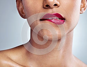 Thats awfully tempting. Closeup shot of an unrecognizable young woman posing in studio against a grey background.