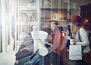 Thats exactly what you had in mind. two best friends out shopping in a clothing store.