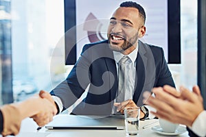 And thats how you win at business. a young businessman and businesswoman shaking hands during a meeting in a modern