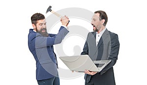 Thats the last straw. Angry businessmen hit laptop with hammer. De-stressing method. Bearded men got angry with computer