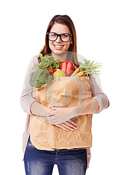 Thats my grocery shopping done. Portrait of an attractive young woman holding a bag of groceries.
