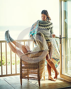 Thats a surefire way to have a good morning. a young couple relaxing on their balcony. photo
