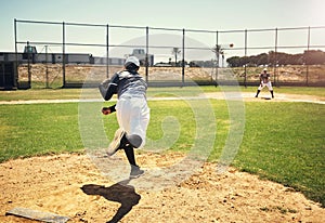 Thats the way the ball flies. a young man pitching a ball during a baseball match.