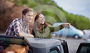 Thats the way. a young couple enjoying themselves on a road tirp.