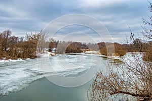 Thawing in the ice of a frozen river