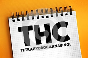 THC - Tetrahydrocannabinol is the principal psychoactive constituent of cannabis, text concept on notepad